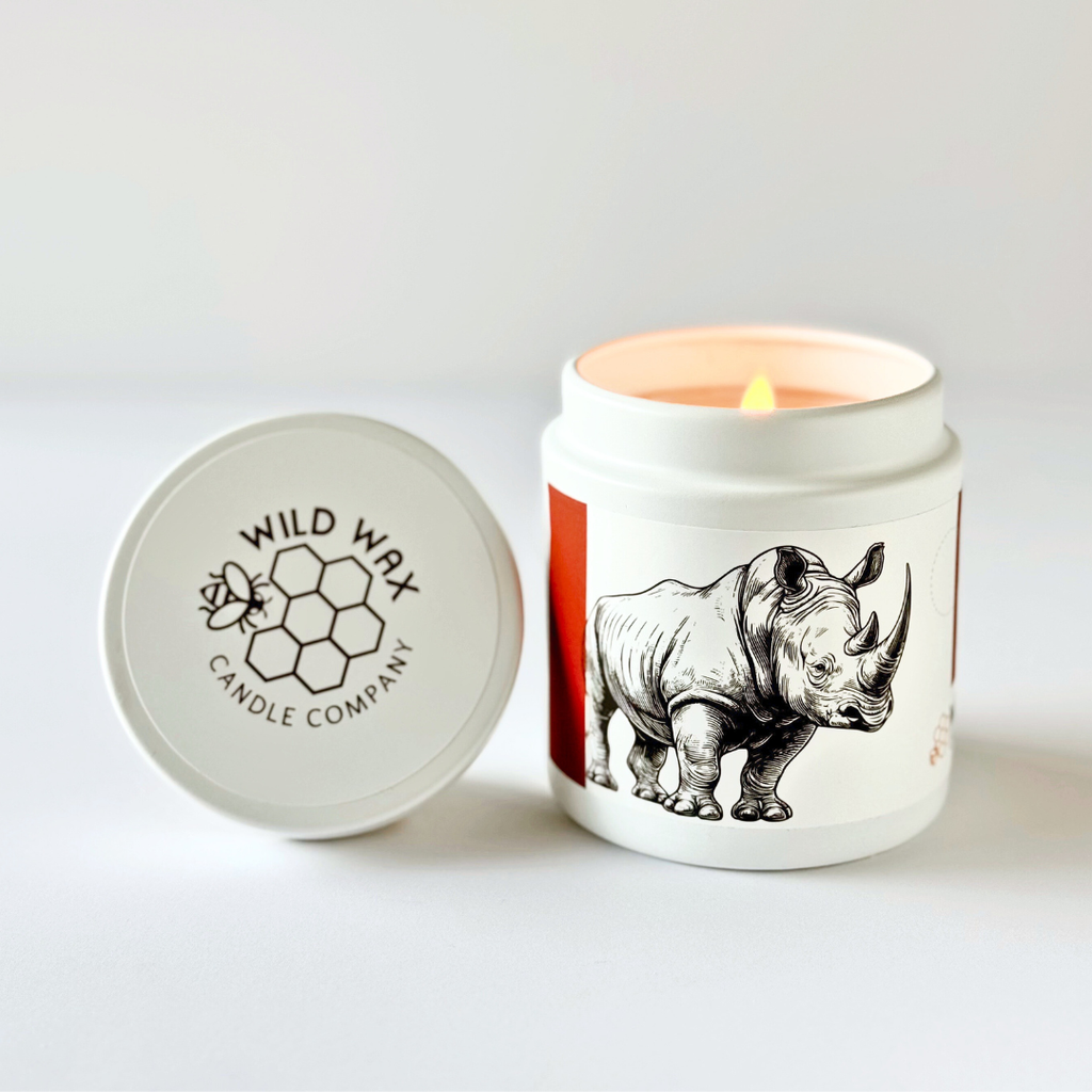 Hand-poured coconut wax candle scented with oakmoss featuring a rhino design