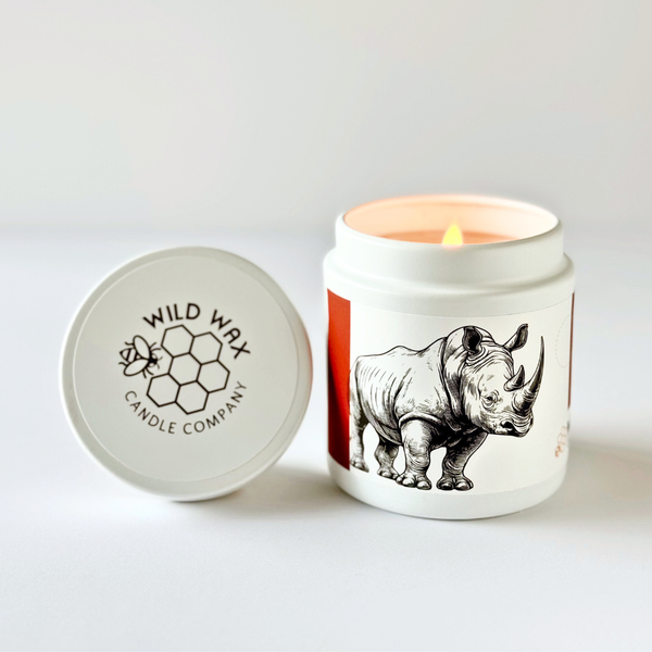 Hand-poured coconut wax candle scented with oakmoss featuring a rhino design