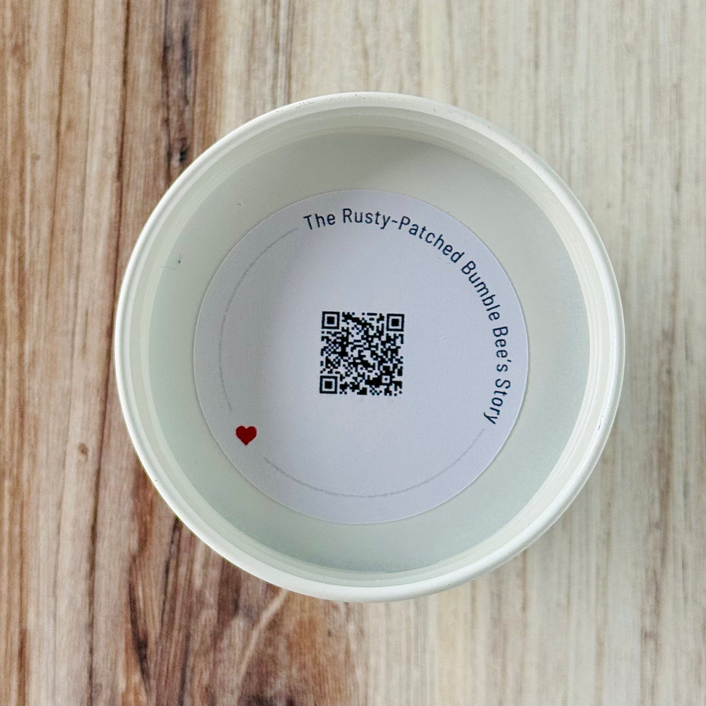Product detail showing candle lid QR code linking to endangered bumble bee conservation content