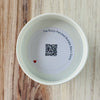 Product detail showing candle lid QR code linking to endangered bumble bee conservation content