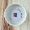 Product detail showing candle lid QR code linking to endangered caribou conservation content
