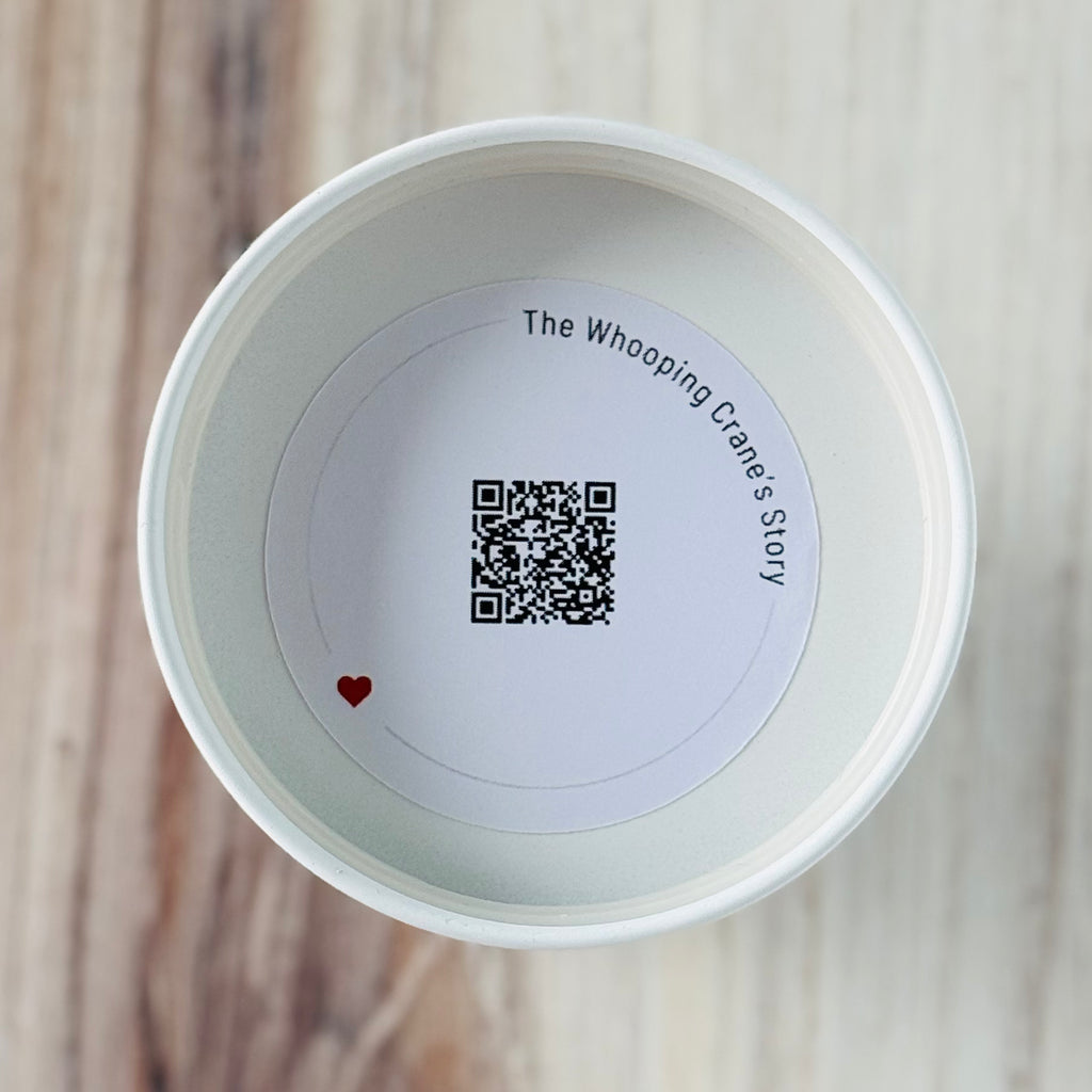 Product detail showing candle lid QR code linking to endangered crane conservation content
