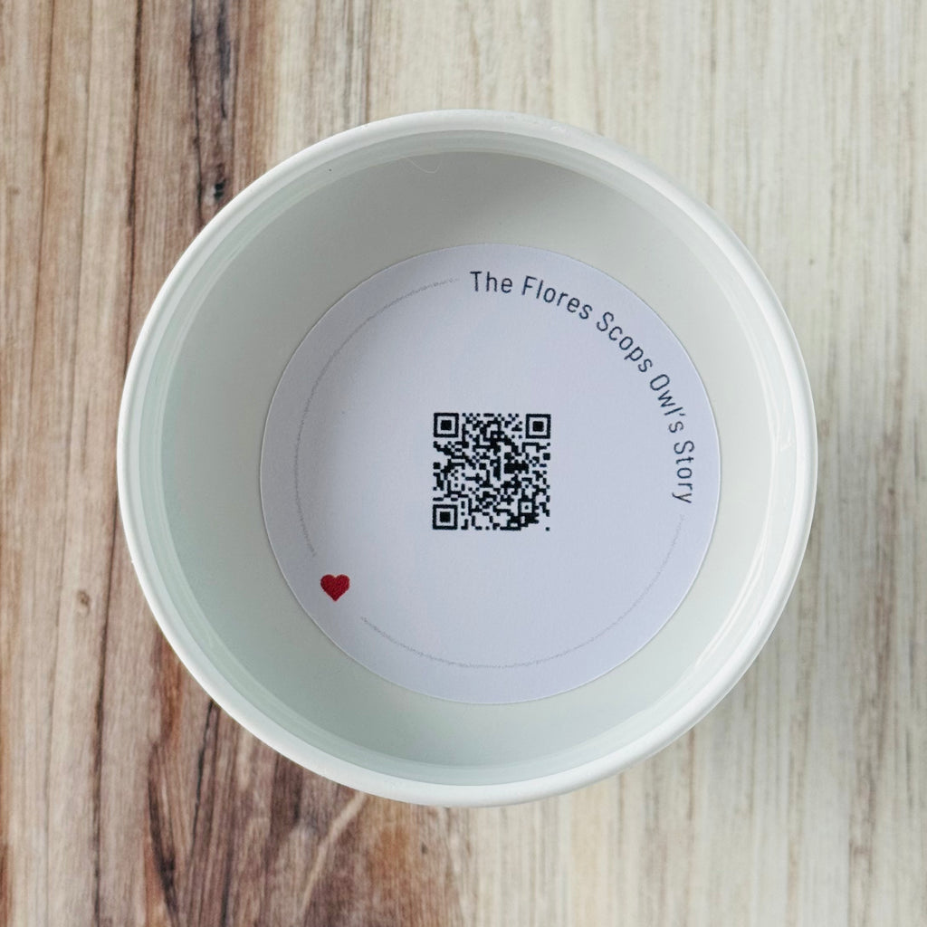 Product detail showing candle lid QR code linking to endangered rhino conservation content