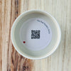 Product detail showing candle lid QR code linking to endangered rhino conservation content