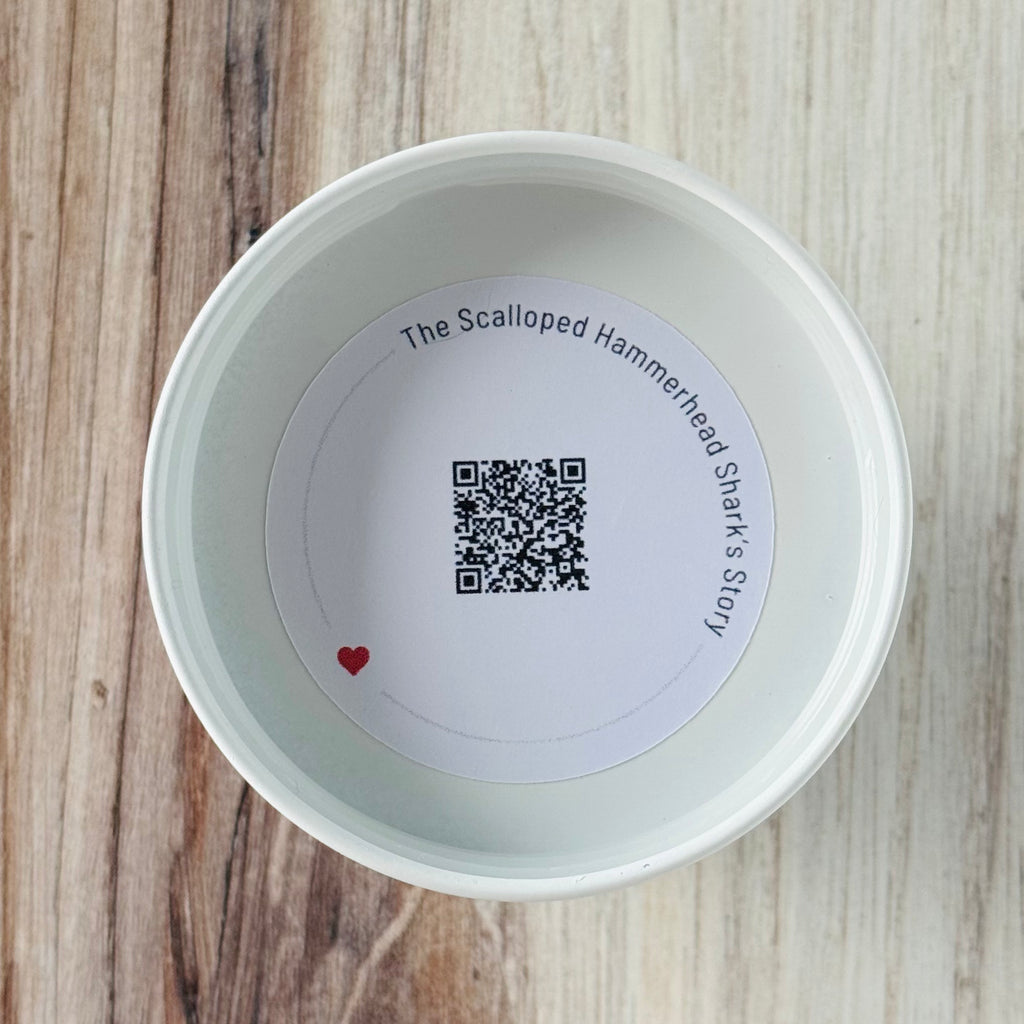 Product detail showing candle lid QR code linking to endangered shark conservation content