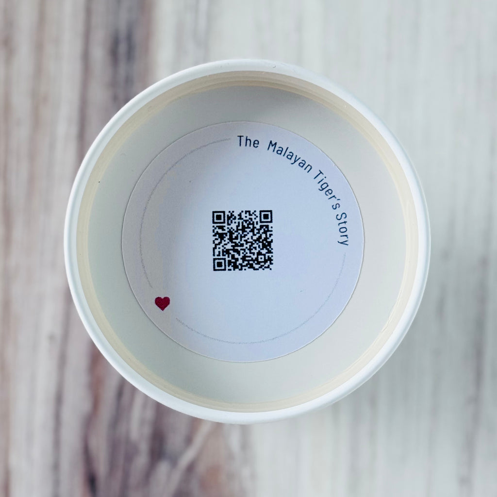 Product detail showing candle lid QR code linking to endangered rhino conservation content