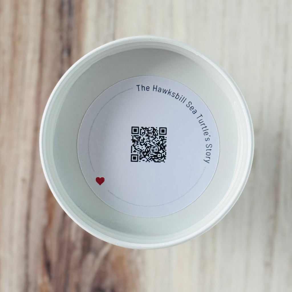 Product detail showing candle lid QR code linking to endangered turtle conservation content
