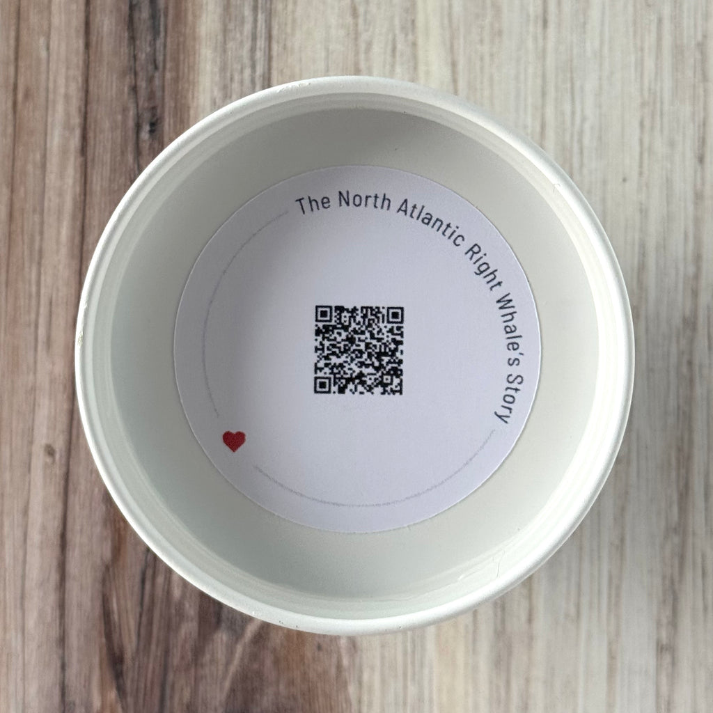 Product detail showing candle lid QR code linking to endangered whale conservation content