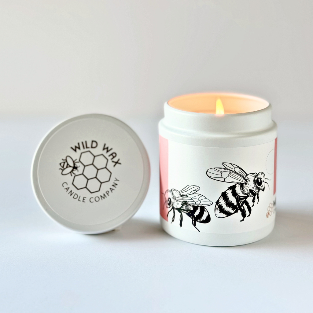 Candle with bumble bee design and a 'Wild Wax Candle Company' branded lid on a white background