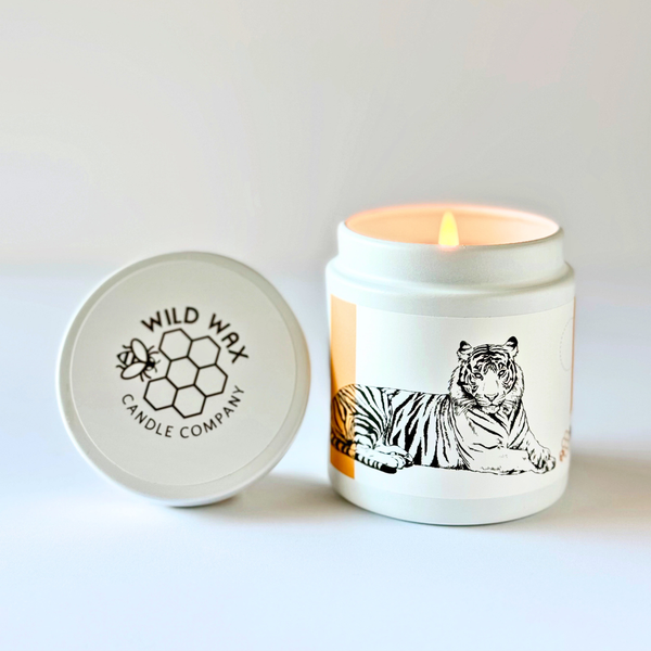 Hand-poured coconut wax candle scented with blood orange featuring a tiger design