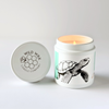 Hand-poured coconut wax candle scented with orchard pear featuring a turtle design