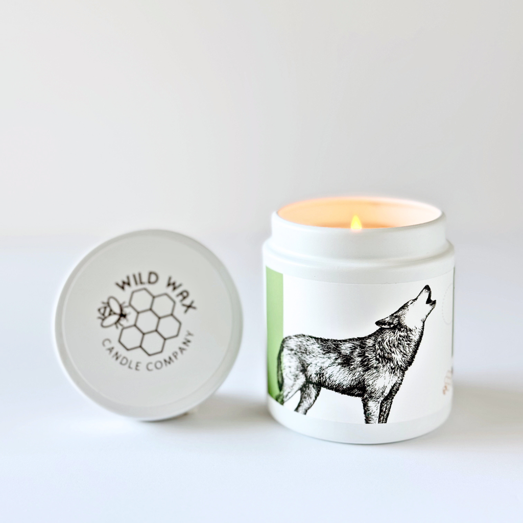Hand-poured coconut wax candle featuring a wolf design and eastern fir scent